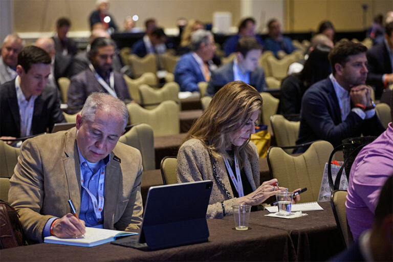 Man and women taking notes